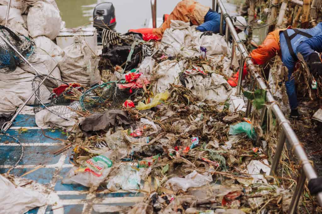 Trash on a garbage boat on a Bali river