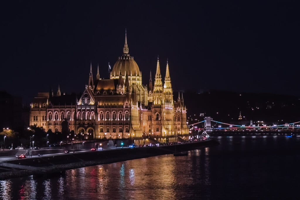 Budapest Parliament reflecting in the Danube River at night.