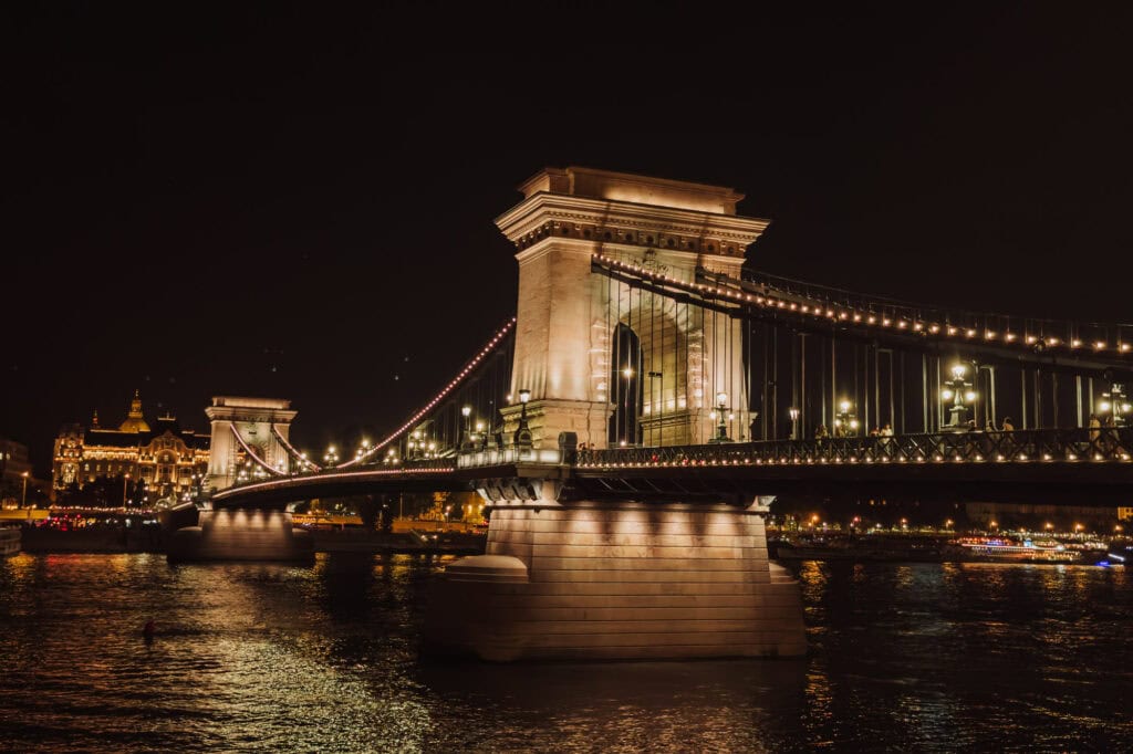 The bridgest lit up at night over the Danube River in Budapest Hungary