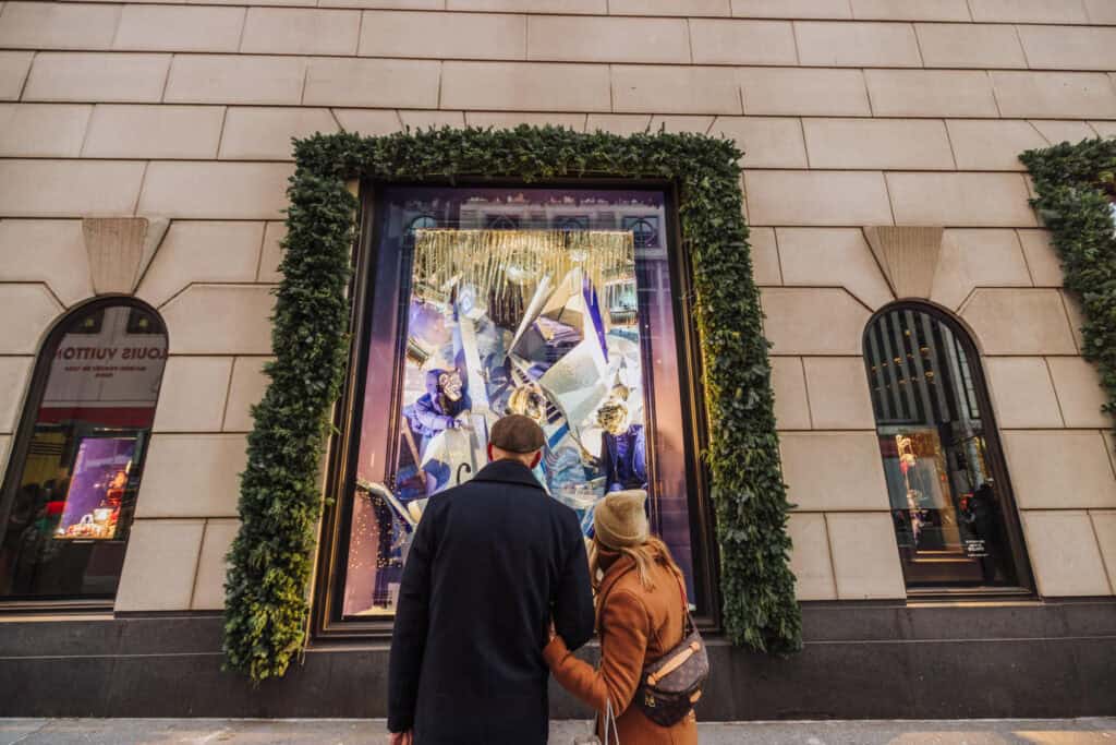 People looking at Christmas displays in the windows along 5th Avenue in New York